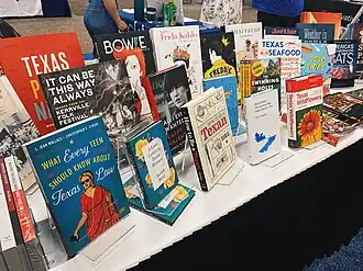 A table display of books published by the University of Texas Press.