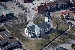 A white church with blue roof seen from the sky