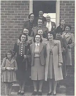 Some of Tallangatta VAOC members pose at the steps of the observation post - circa 1944. Front row from left: Olga Smith, Mrs A. Smith, Maise Tait, Thelma Butler. Second Row - Mrs Ballantyne, Helen Tait, Mrs J. L. Fisher. Third row: Madge Maddock, Mrs H. G. Heath and daughter behind. Fourth row: Miss Myrtle Ruby, unknown, Mrs Pearl Foster. Photo: Thelma Moyle.