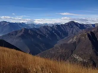 Val Grande, Pizzo Proman (the taller mountain on the right), Cicogna (the small village on the bottom-right corner) and Monte Rosa (left, covered by clouds), seen from Pizzo Pernice