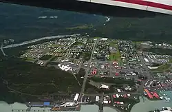 An aerial view showing the townsite, the harbor, Port Valdez, the lower Mineral Creek valley, and Blueberry Hill