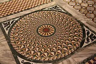 intricately patterned floor with coloured marbles
