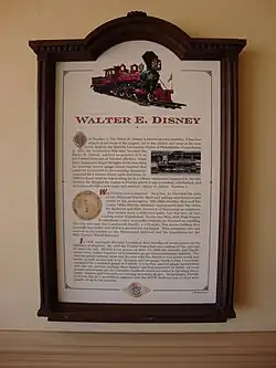 A plaque representing information about a red steam locomotive