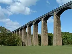 The Pontcysyllte Aqueduct over the River Dee viewed from the Vale of Llangollen, with a narrowboat crossing