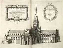 The engraving of a large Gothic cathedral. The central tower is buttressed and with an imposing wooden spire.