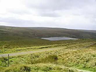 A small rectangular reservoir surrounded by upland