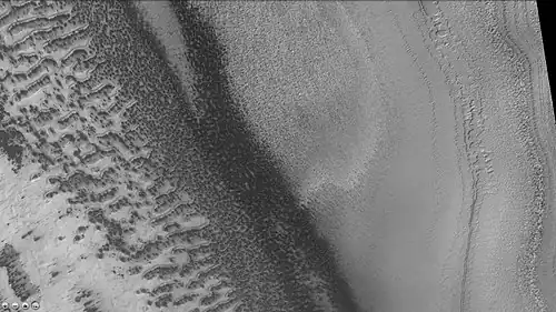 Reynolds crater showing layers and dark spots from defrosting, as seen by CTX camera (on Mars Reconnaissance Orbiter). Area is covered by frost, when the frost disappears the underlying dark ground is exposed. Layers are also visible. Note: this is an enlargement of a previous image of Reynolds crater.