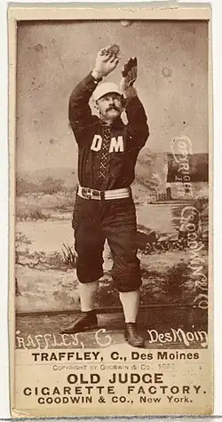 Standing man in baseball uniform catching a ball