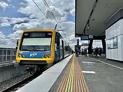 Northbound view of Lilydale station, with X'Trapolis 174M at the platform, the screen tower station feature can be seen further up the platform
