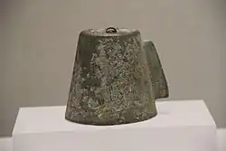 A small ancient bell in a museum display