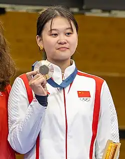 Photo of Zhang holding her Olympic bronze medal