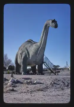 Large concrete Brontosaurus sculpture nearly completed in desert landscape