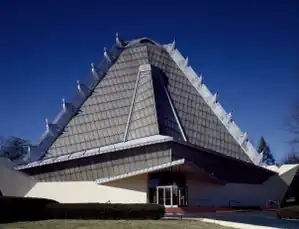 Exterior of Beth Shalom Synagogue, a concrete, steel, and glass building with a pyramidal roof