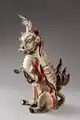 Porcelain qilin with the head and scaly body of a dragon, tail of a lion and cloven hoofs like a deer, its body enveloped in sacred flames (Qing dynasty, c. 1750)
