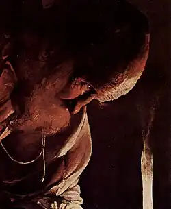 Pochylony Józef w blasku świecy