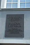 Tablica na ścianie kamienicy nr 21, upamiętniająca ścięcie Mikołaja z Ryńska na rynku w Grudziądzu