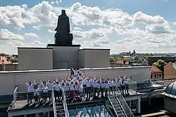 grono radosnych ludzi na balkonie widokowym AGH ulokowanym na dachu budynku A0