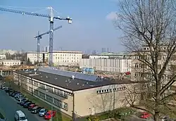 Kompleks budynków przy ul. Pasteura: budowa Centrum Nowych Technologii II (CeNT II) UW, po prawej Środowiskowe Laboratorium Ciężkich Jonów UW, na pierwszym planie nieistniejąca już hala maszyn przy Instytucie Geofizyki UW (po prawej za drzewem)