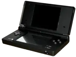 An opened clamshell dual-screen handheld device. A camera is embedded in the internal hinge.