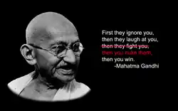 Na czarnym tle po lewej stronie znajduje się czarno-białe zdjęcie Mahatmy Gandhiego. Po prawej stronie znajduje się biały napis „First they ignore you, then they laugh at you, then they fight you, then you win. -Mahatma Gandhi”. Napis „then they fight you” jest przekreślony i zastąpiony czerwonym napisem „then you nuke them”.