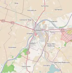 Mapa konturowa Malborka, blisko centrum u góry znajduje się ikonka zamku z wieżą z opisem „Zespół zamkowy w Malborku”
