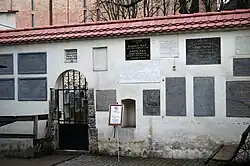 Tablice pamiątkowe i brama na cmentarz