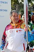 Szojgu z pochodnią olimpijską na Olimpiadzie w Soczi, 2014 rok