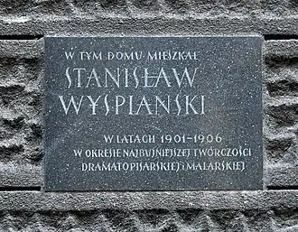 Tablica pamiątkowa na kamienicy związanej z malarzem.