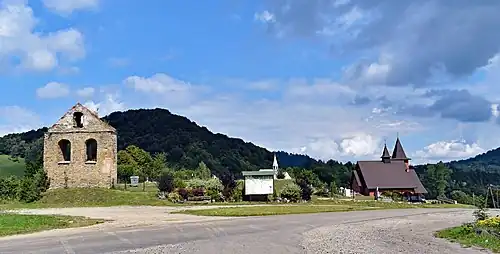 Centrum wsi, cmentarz, za nim góra Monaster