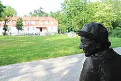 Ławeczka Wisławy Szymborskiej, w tle Kórnicki Ośrodek Kultury